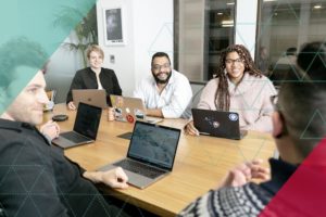Diversity in the Boardroom, image of diverse people sitting around a boardroom table